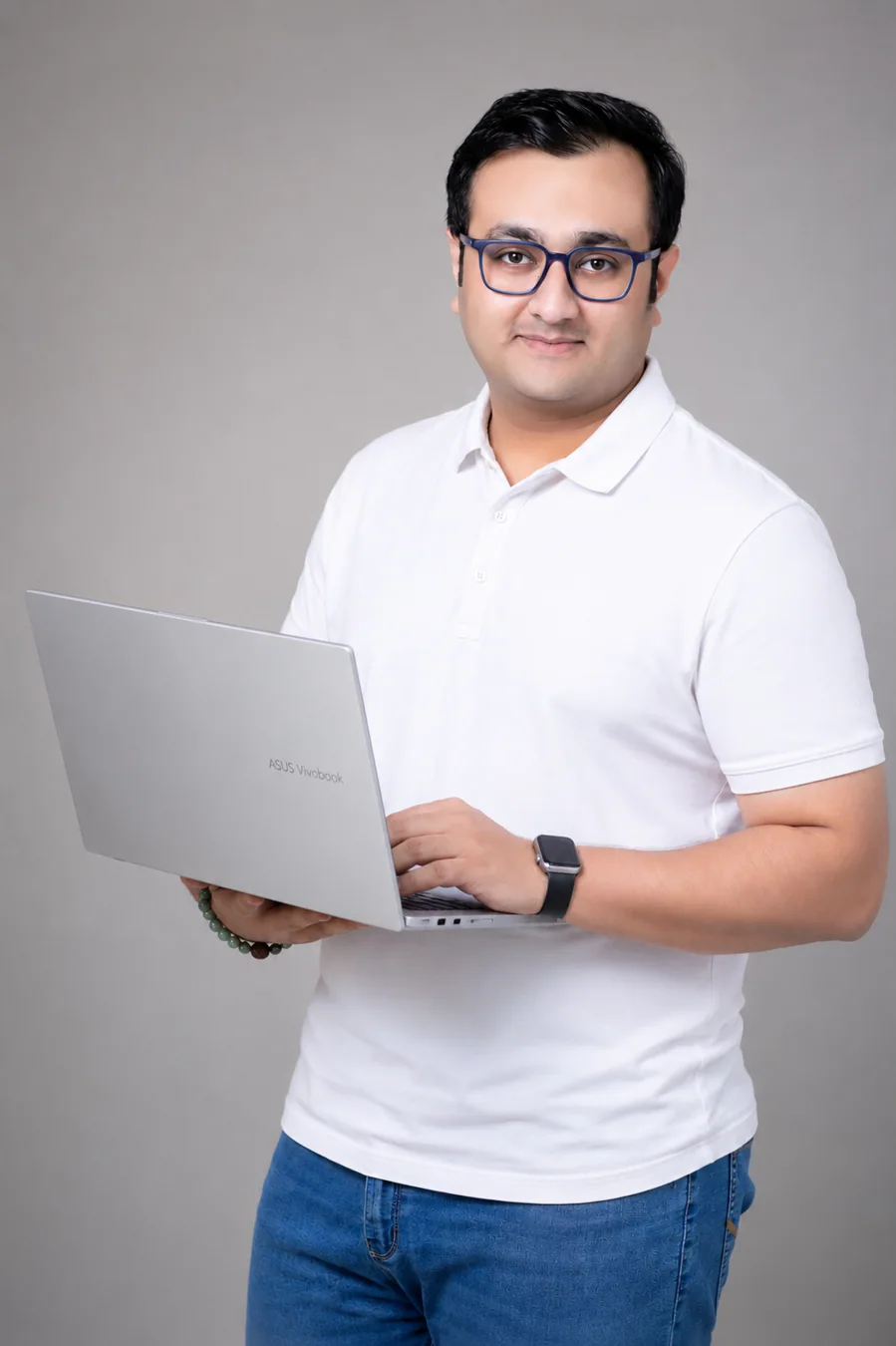 Rishikesh K. Mahajan holding a laptop, founder of Orbitt Media